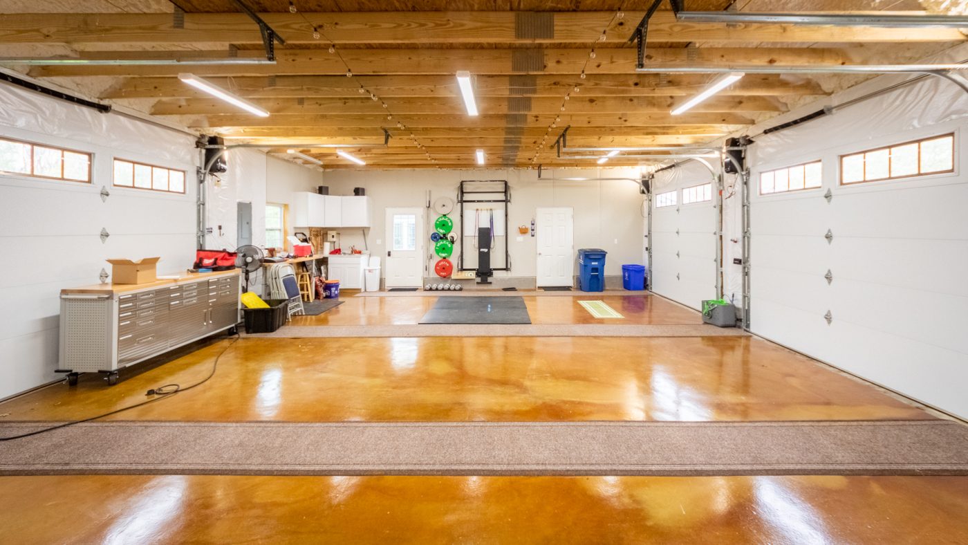 interior of garage with workout equipment and a work bench