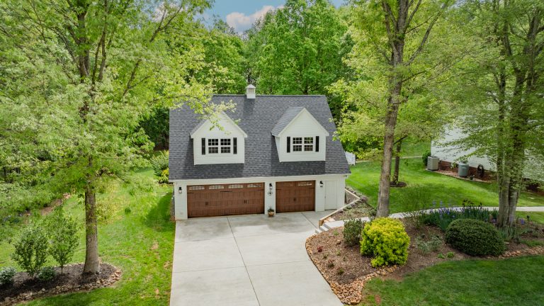 Aerial photo of the front of the ivory 32x36 workshop with 2 10-foot dormers in the attic and 2-car garage