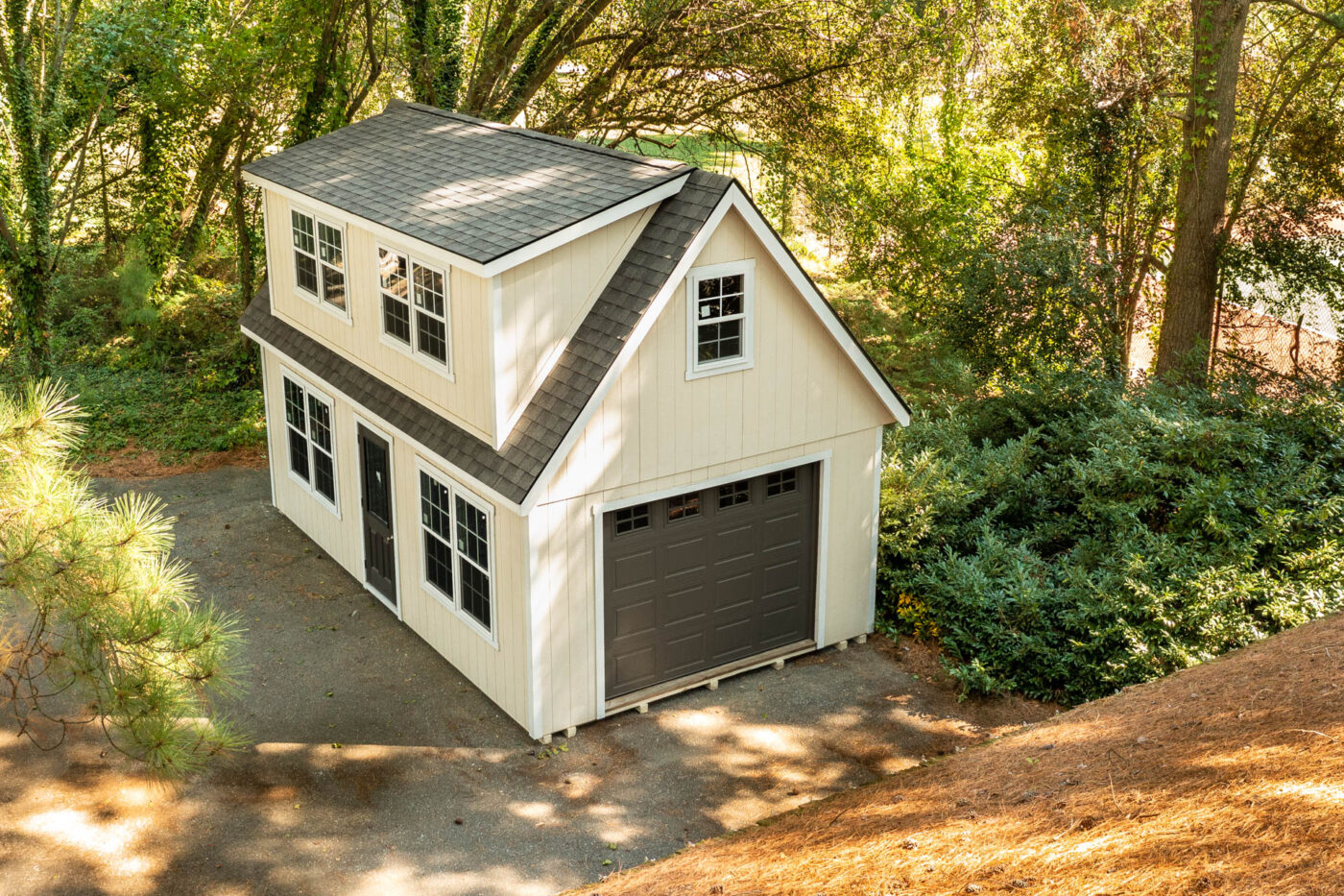 a creme 2-story legacy single-car garage with white trim and dark grey doors for sale in Lynn, MA