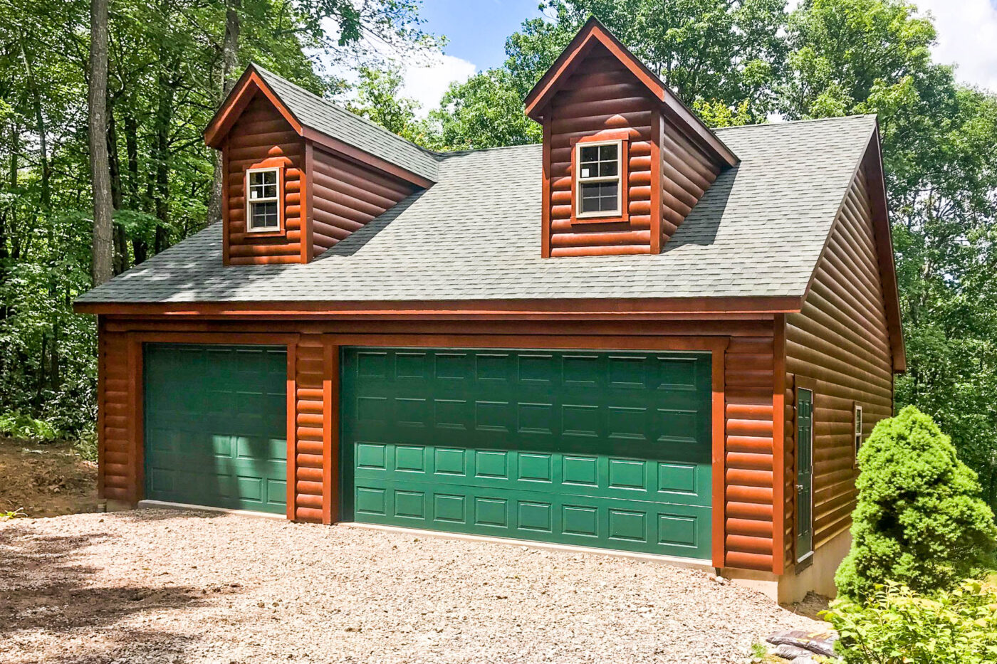 a log siding 3-car garage with green garage doors for sale in Lynn, MA