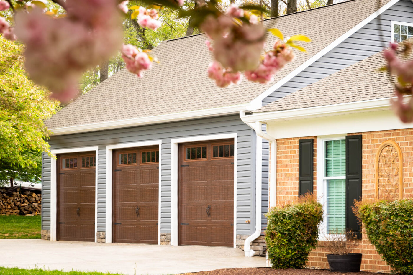 a blue/gray 3-car garage with brown garage doors for say in Lynn, MA