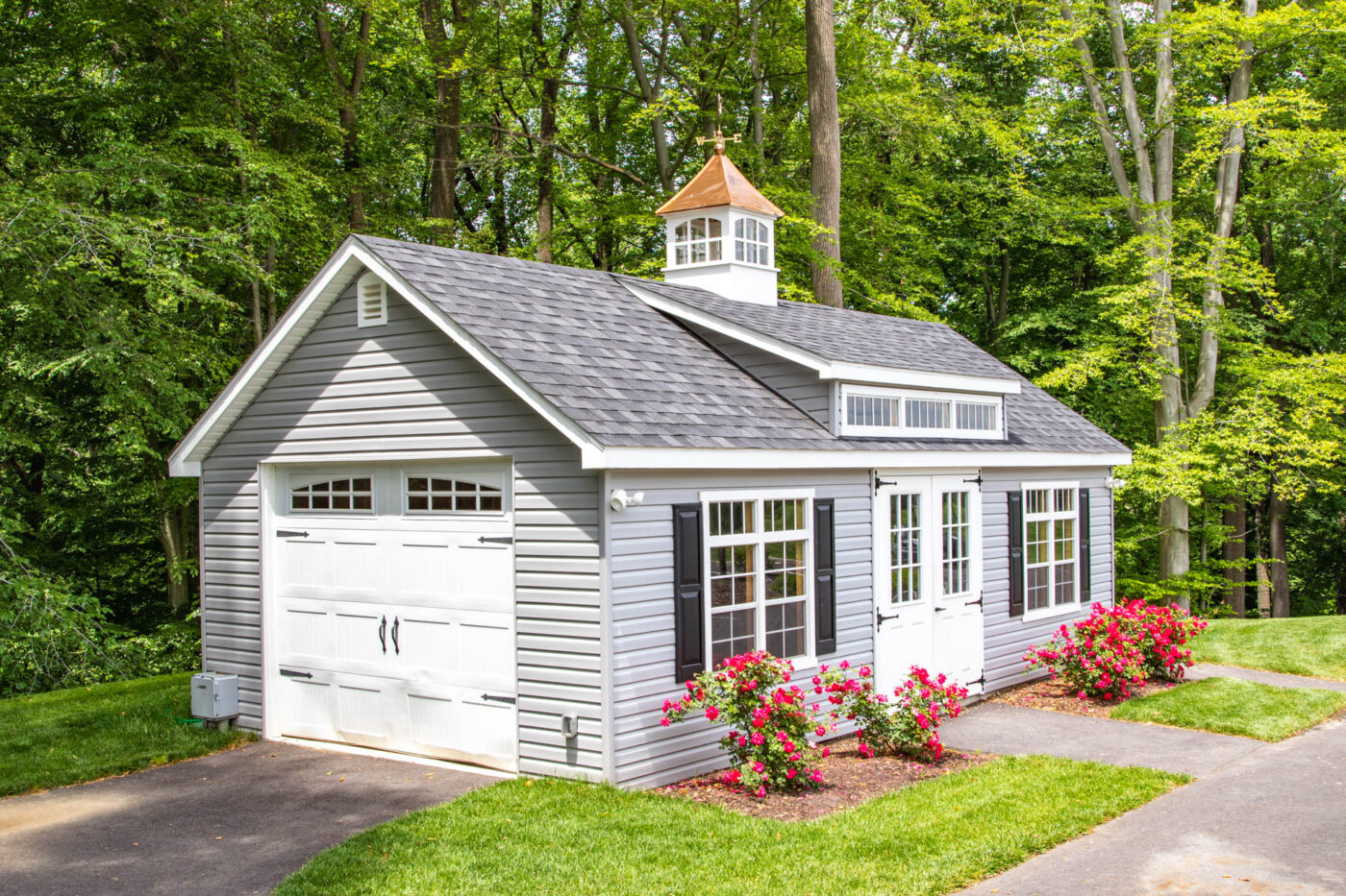 a grey single-car garage with white doors and windows and black shutters for sale in New Bedford, PA