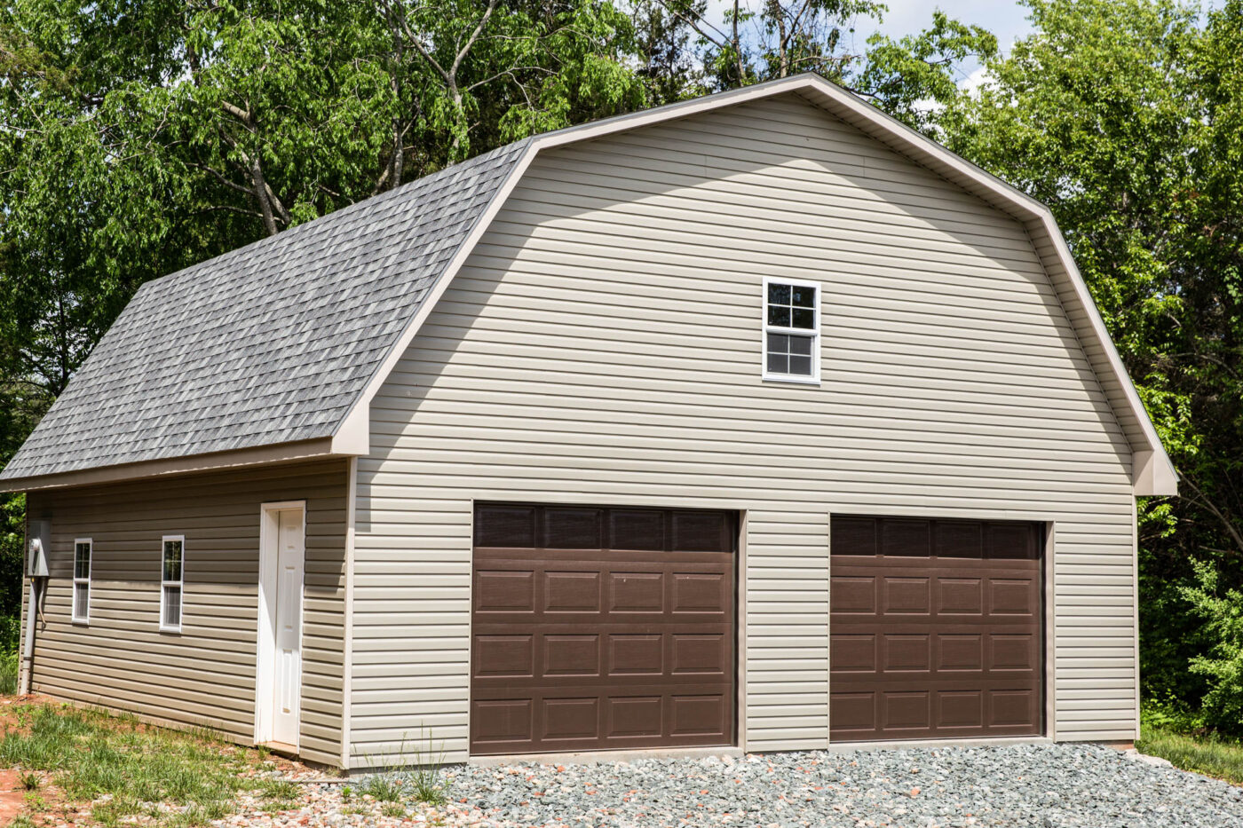 tan barn-style garage with brown garage doors for sale in Fayetteville, NC