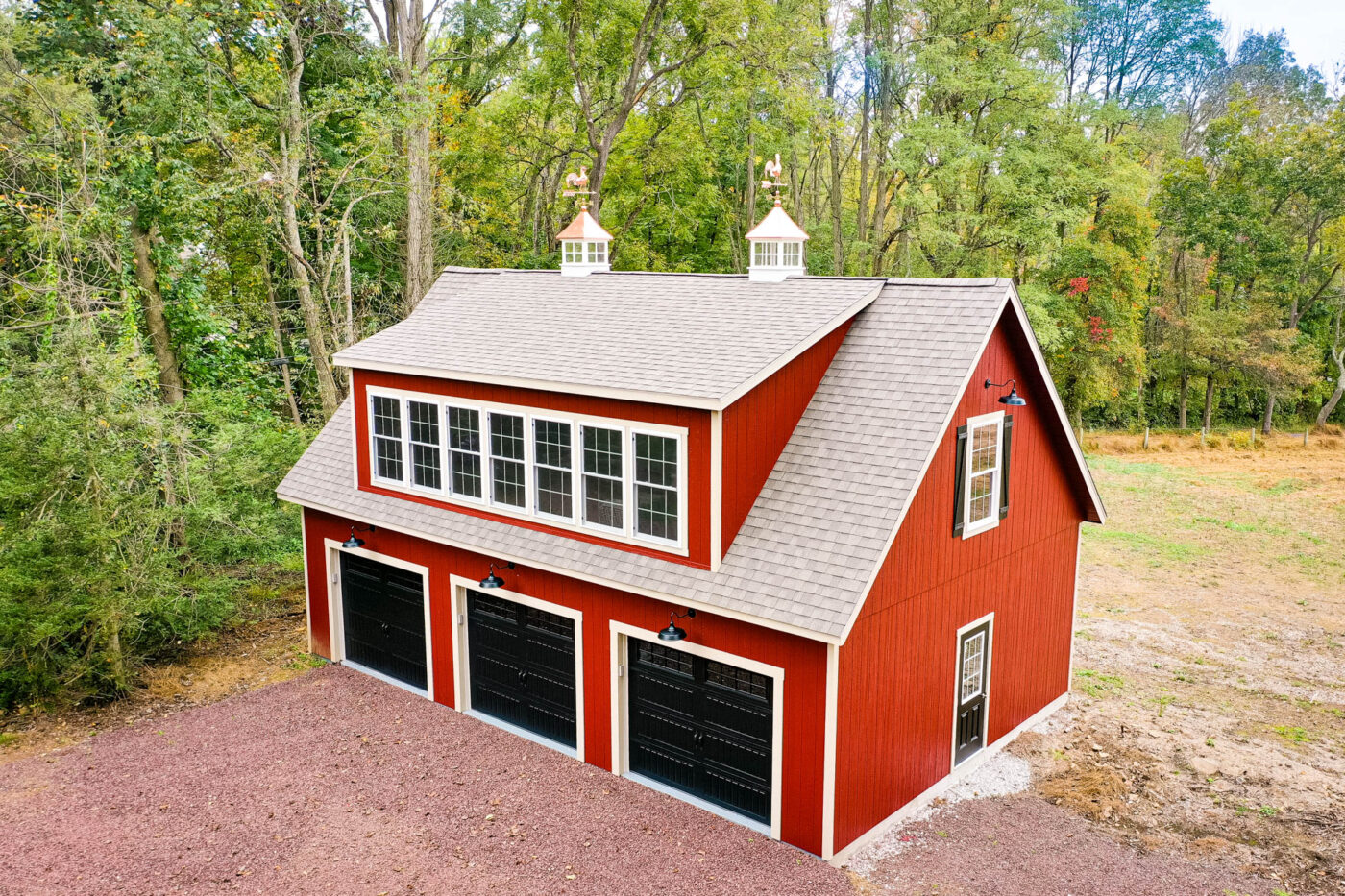 red 3-car garage with white trim and black doors and 2 cupolas for sale in Columbia, SC