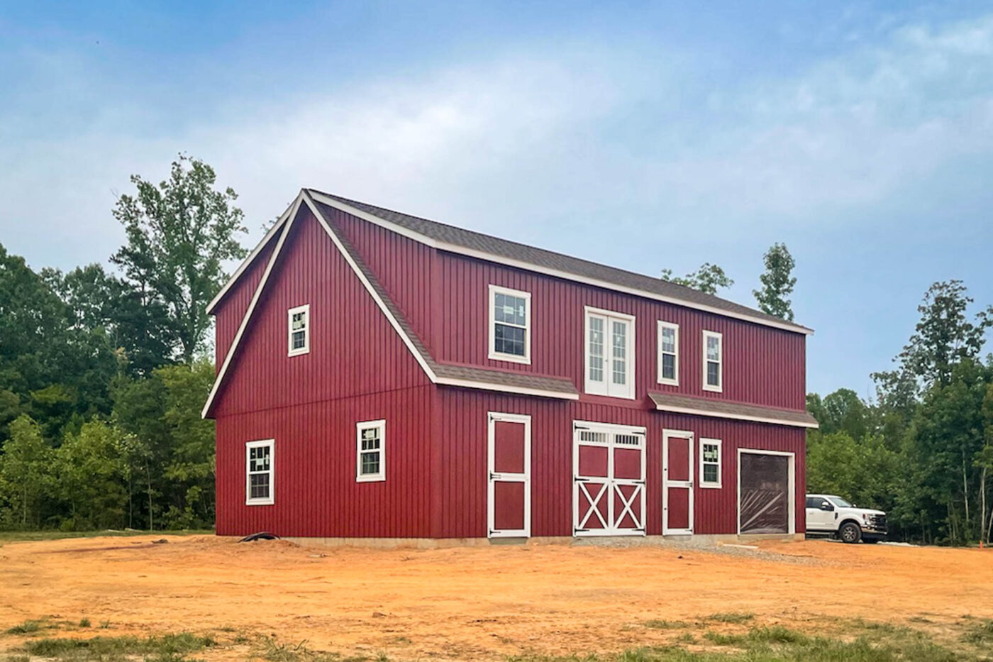 a red 2-story legacy workshop garage with white trim built for sale near Alexandria, VA