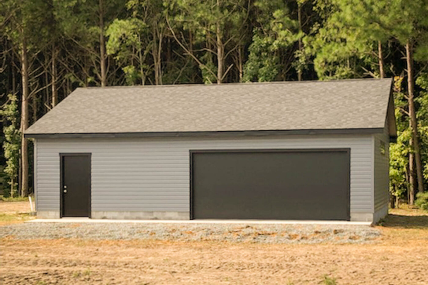 a grey 2-car garage with black doors built for sale near Chesapeake, VA