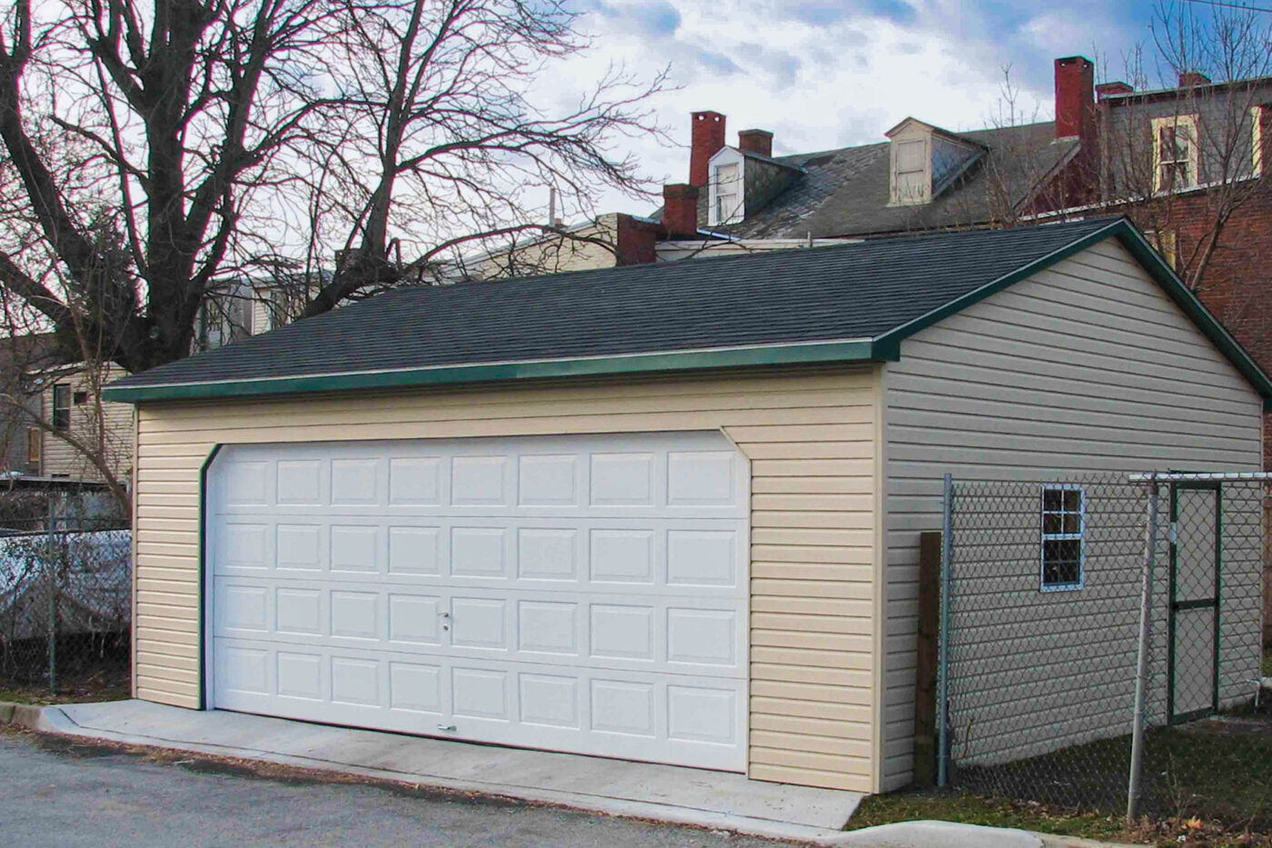 tan one-car garage with a white overhead door for sale in NC