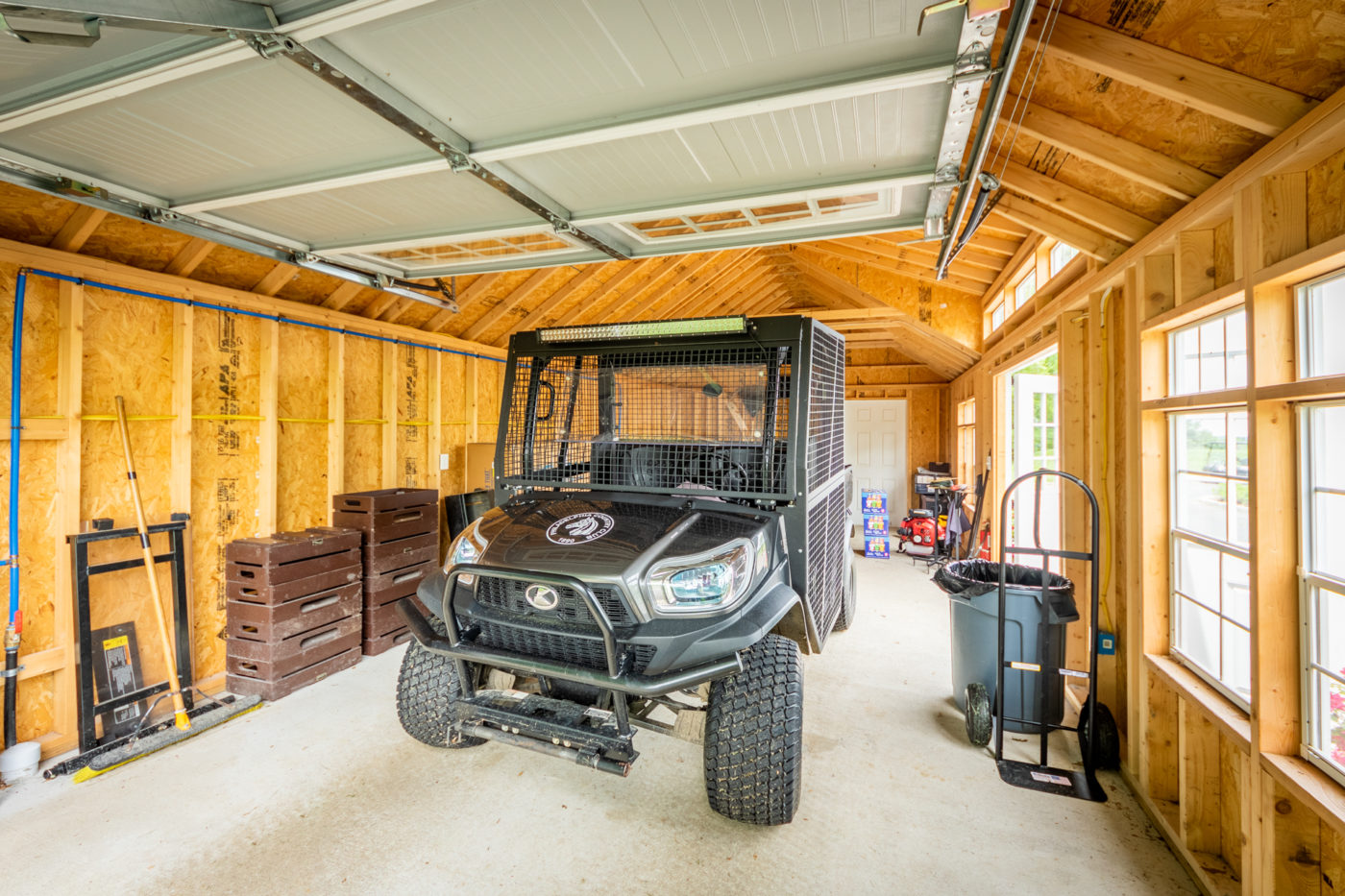 A single-car garage workshop storing an ATV