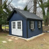 a dark blue 10x12 premier workshop shed in penn valley, pa with black trim and shutters