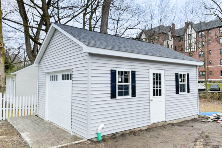 gray classic workshop single-car garage in Pelham, NY with black shutters
