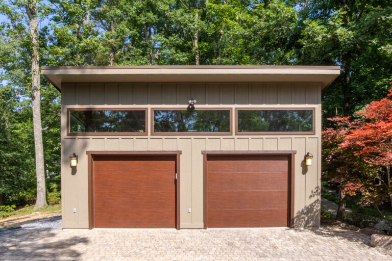 a tan Modern 2-Car Garage in with brown doors and trim built by Sheds Unlimited in Davidsonville, MD