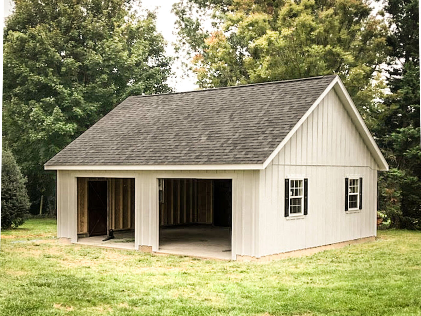 the exterior of a white Single-story Workshop 2-car garage in Mt. Airy, MD with black shutters