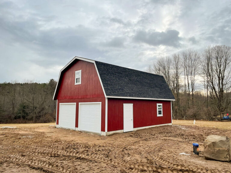 a red MaxiBarn with Attic 2-Car Garage with white trim in ludlow, ma