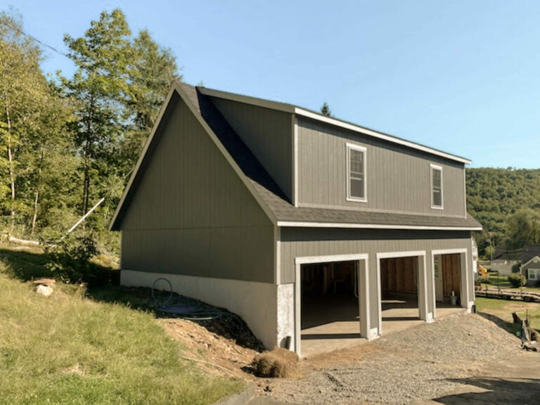 the exterior of a grey 2-story Workshop 3-car garage in beacon falls, CT with white trim and dual black shingles
