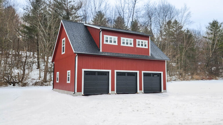 Red legacy 2-story workshop 3-car garage with white trim and large dormer