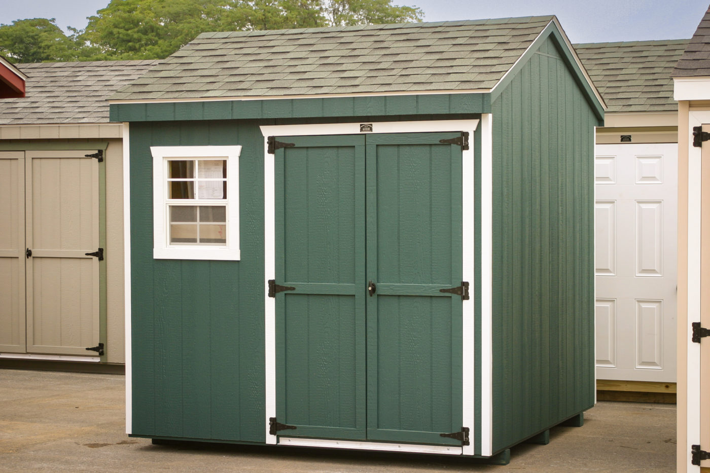 A small shed with green siding