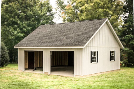 the exterior of a white single-story workshop 2-car garage in Mt. Airy, MD with black shutters