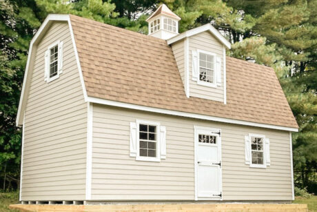the exterior of a custom painted 2-Story MaxiBarn shed in West Chester, PA with white trim, white z shutters, and Earthtone Cedar shingles
