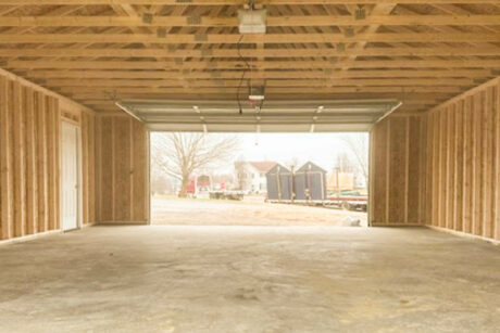 the interior of a 24x32 single-story workshop 2-car garage in falling waters, wv with white trim and sandstone vinyl siding