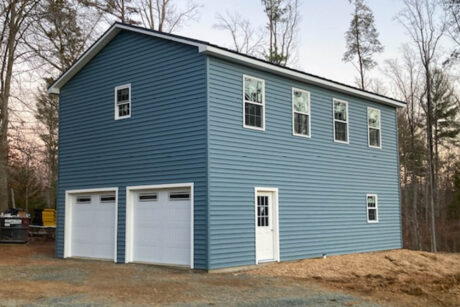 blue 2-story detached garage with high walls