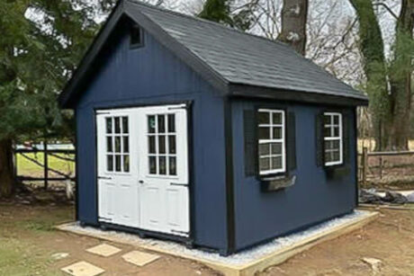 a dark blue 10x12 premier outdoor storage shed in penn valley, pa with black trim and shutters
