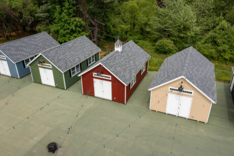 5 premier workshop sheds of 5 different colors with white trim and architectural shingles and one transome window and black shutters