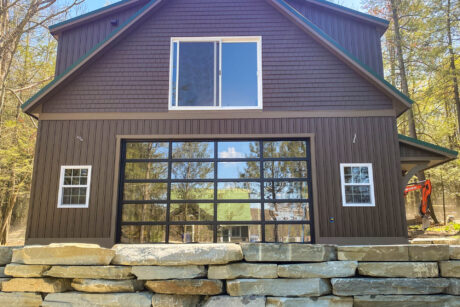 a custom vinyl espresso 28x32 Legacy 2-Story Workshop 2-Car Garage with metal standing seam Forest Green roof and 2 large dormers