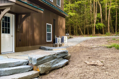 a custom vinyl espresso 28x32 Legacy 2-Story Workshop 2-Car Garage with metal standing seam Forest Green roof and 2 large dormers