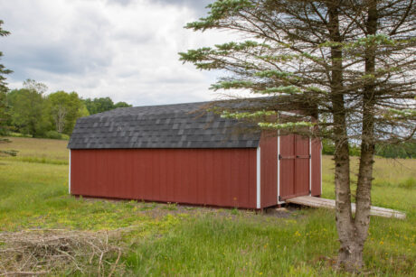 red 12x18 standard minibarn shed with gray shingles and white trim built by Sheds Unlimited in Dushore, PA
