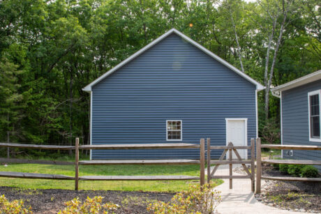 the exterior of a Pacific Blue Attic Workshop 2-Car Garage with white trim built by Sheds Unlimited in Jim Thorpe, PA