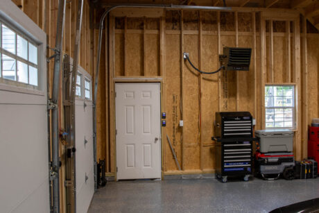 the interior of a Pacific Blue Attic Workshop 2-Car Garage with white trim built by Sheds Unlimited in Jim Thorpe, PA
