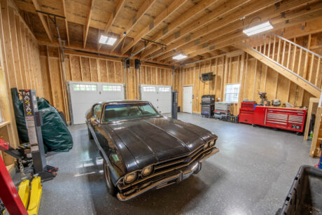 the interior of a Pacific Blue Attic Workshop 2-Car Garage with white trim built by Sheds Unlimited in Jim Thorpe, PA