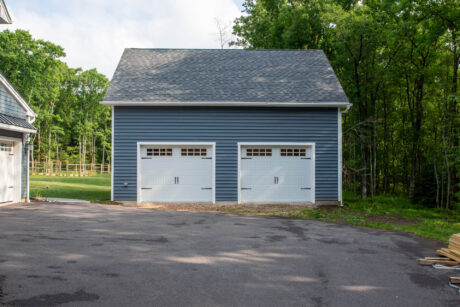 the exterior of a Pacific Blue Attic Workshop 2-Car Garage with white trim built by Sheds Unlimited in Jim Thorpe, PA