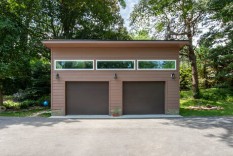 a custom 20x26 modern 2-car garage with custom brown paint and transom windows built buy Sheds Unlimited in Milford, DE