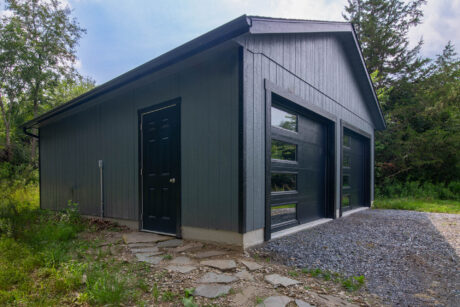single-story workshop 2-car garage with dark gray pain and black trim and doors built by Sheds Unlimited in Clinton Corners, NY