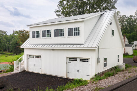 a white 2-story workshop 3-car garage built by Sheds Unlimited in Southbury, CT