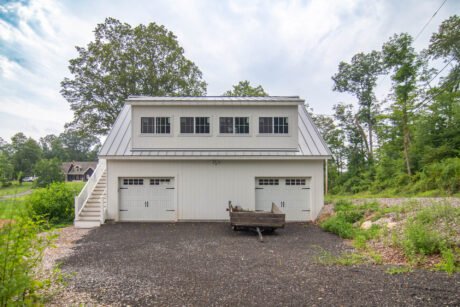 a white Legacy 2-story workshop 3-car garage built by Sheds Unlimited in Southbury, CT