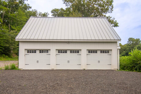 a white Legacy 2-story workshop 3-car garage built by Sheds Unlimited in Southbury, CT