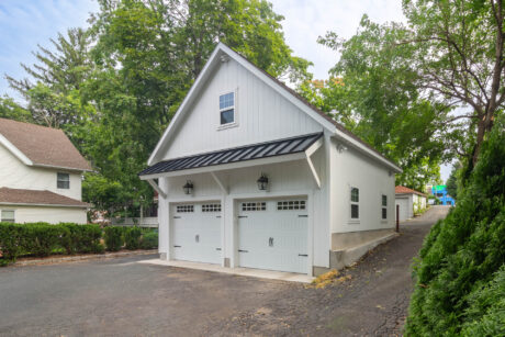 a White 24x20 Attic Workshop 2-Car Garage with wood siding and a hip roof in Greenwich, CT built by Sheds Unlimited