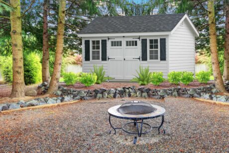 large backyard with beautiful landscape and fire pit 