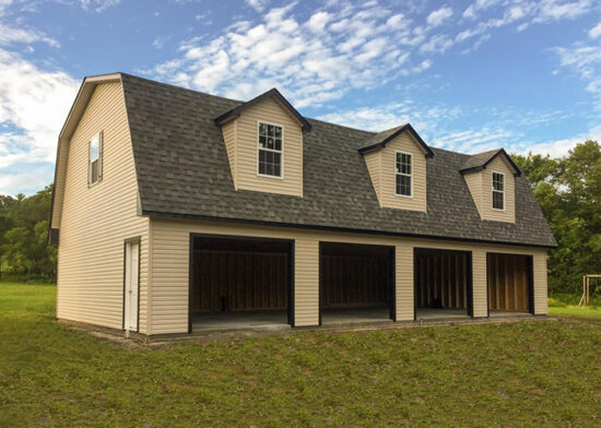 A 2 story four car garage with dormers and vinyl siding
