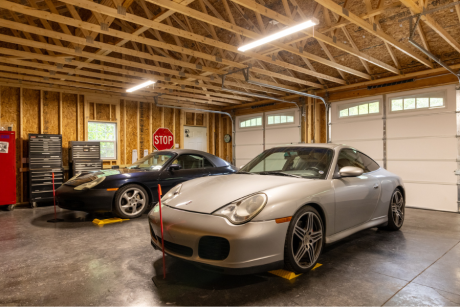 interior of 28x38 garage with two cars parked inside