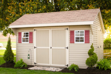 A garden shed kit with brown vinyl siding