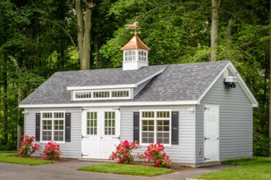 A single-car garage workshop with a dormer and a cupola