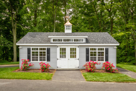 A single-car garage workshop with a dormer and a cupola in the spring