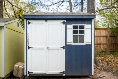8x8 shed with blue wooden siding in a forest in churchton md