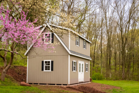 14x24 2 story shed with windows and wood siding between trees in mohnton pa 2