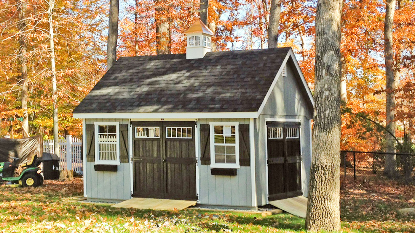 featuring the exterior of a beautiful shed with a shed ramp for the article on how to build a ramp for your shed