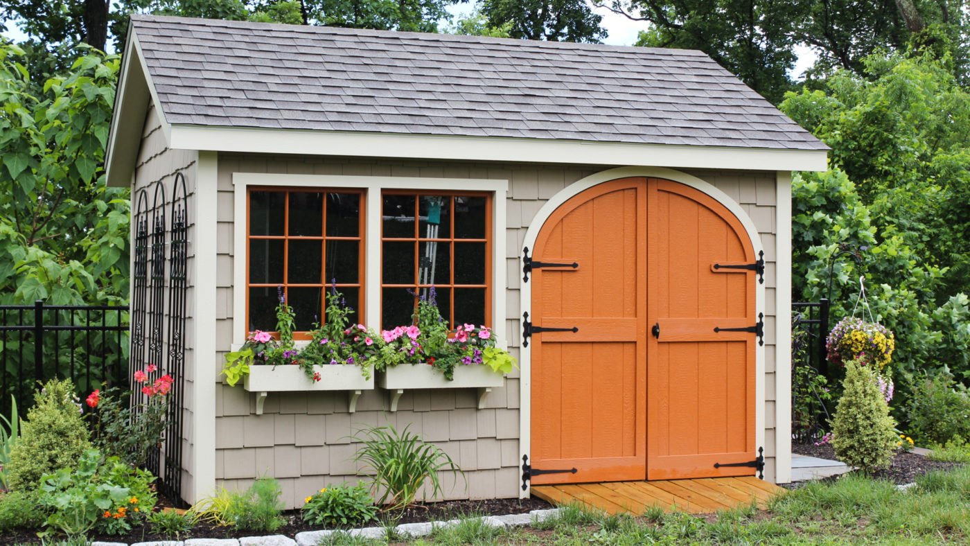 exterior of nice shed with orange doors and with a shed ramp for sale