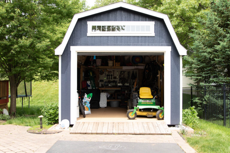lawn mower next to shed ramp
